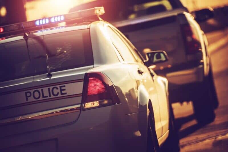 police car stopping a vehicle on the road