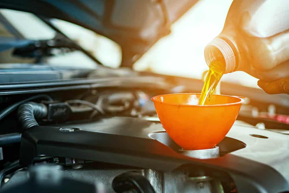 closeup of car oil change with funnel