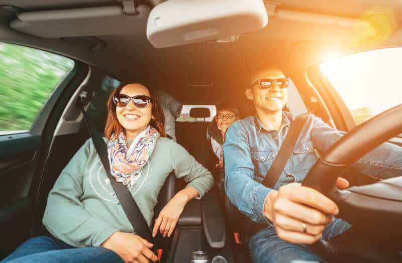 happy family in car with liability insurance