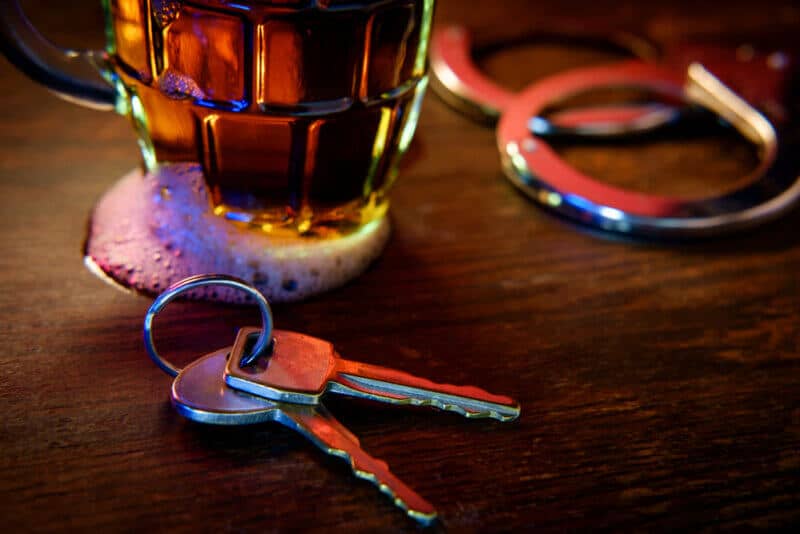 car keys by alcohol and handcuffs