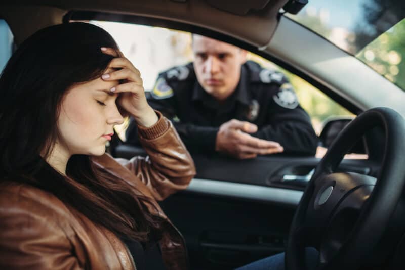 woman getting pulled over by cop