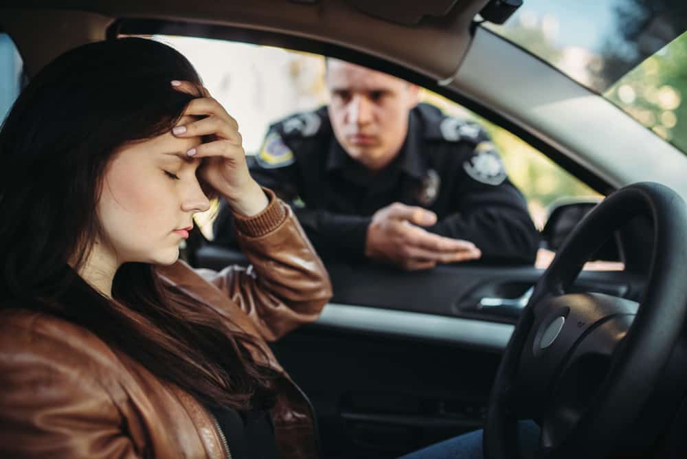 woman getting pulled over by cop