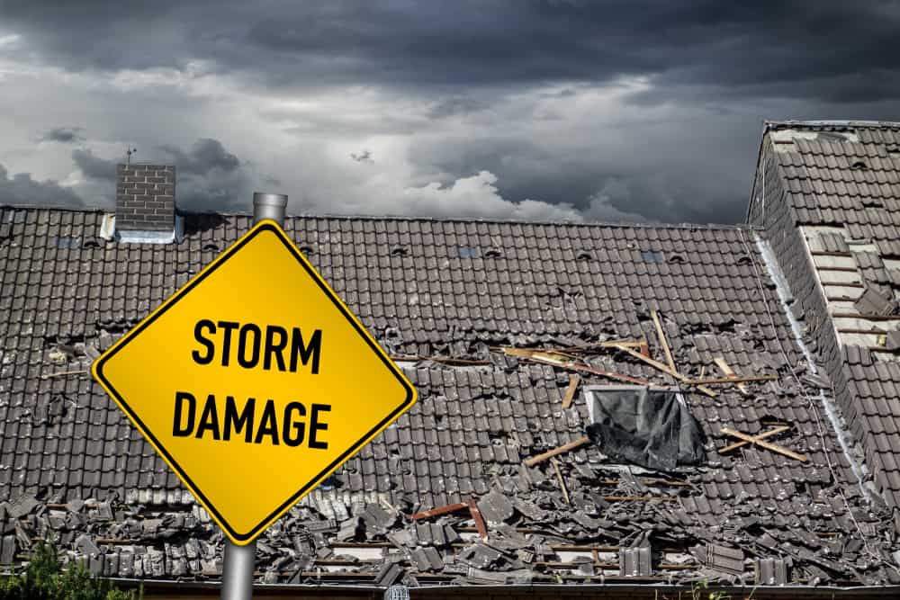 damaged roof with storm damage sign