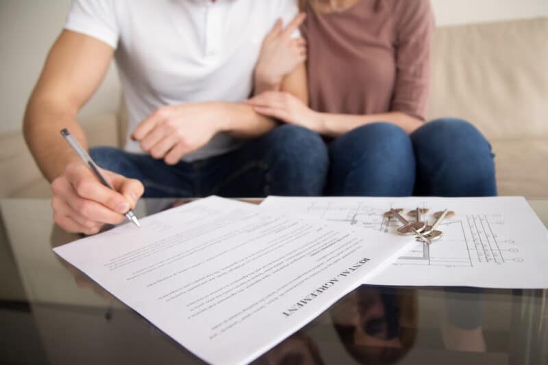 couple signing renters insurance agreement