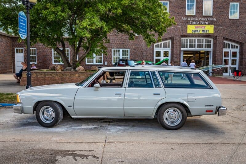 Older station wagon in front of a swap meet