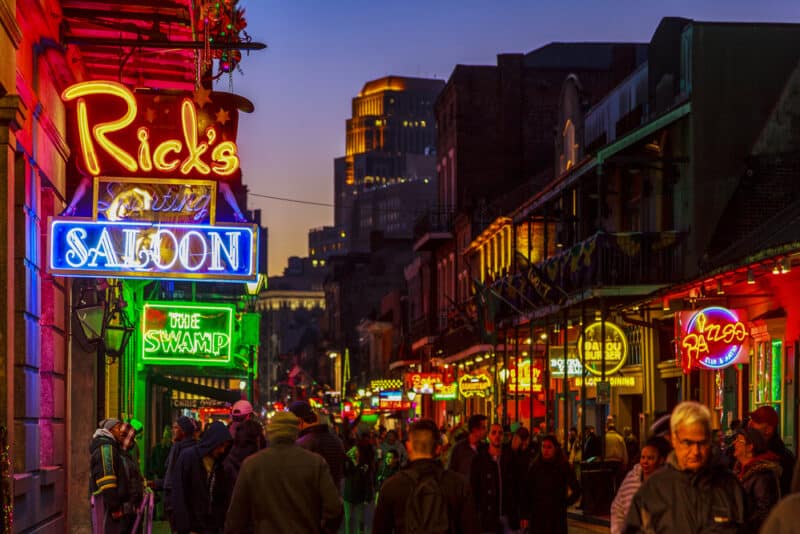 Streets in the French Quarter in New Orleans lit up at night by bar signs